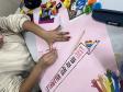 Estudantes produzindo cartazes com mensagens em espanhol em defesa da diversidade