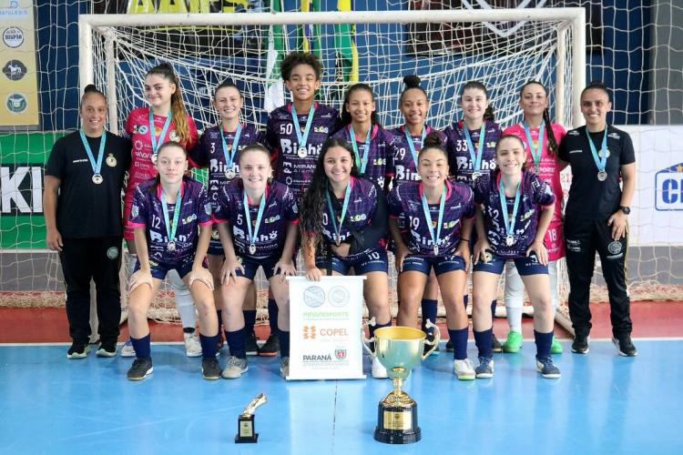 equipe posa para foto oficial, com o troféu